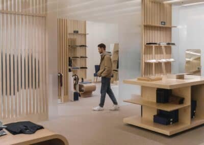 Warm minimalist commercial interior with wood slat paneling and retail shelving