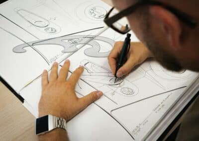 Designer hand-sketching a commercial space layout on paper