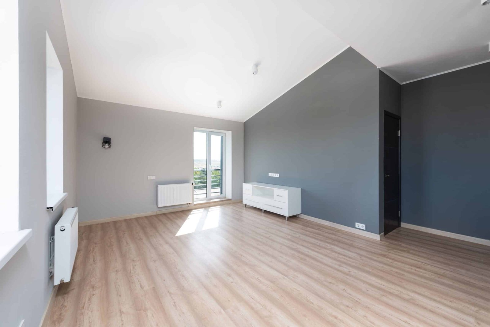 Empty renovated commercial interior with fresh walls and wood flooring, ready for buildout